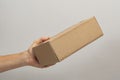 hand holding box to pack product to be sent by mail with copy space. Royalty Free Stock Photo