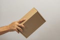 Hand holding box to pack product to be sent by mail with sayings in portuguese. Royalty Free Stock Photo