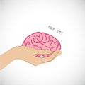 Hand holding a brain with try me text