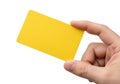 A hand holding a bright yellow rectangular card against a plain background Royalty Free Stock Photo