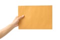 Hand holding brown envelope on white background Royalty Free Stock Photo