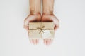 Hand holding brown gift box with happy valentines note, on white background