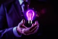 Hand holding bulb. Businessman holding a bright light bulb. Concept of Ideas.