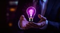 Hand holding bulb. Businessman holding a bright light bulb. Concept of Ideas. Royalty Free Stock Photo