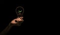 Hand holding bulb with green tree inside isolate on black background Royalty Free Stock Photo