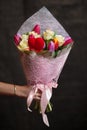 Buquet of various tulips and roses on the dark background