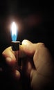 hand holding a burning match, Hand burning a lighter on black background Royalty Free Stock Photo