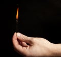 Hand holding burning match stick Royalty Free Stock Photo