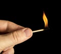Hand holding burning match stick Royalty Free Stock Photo