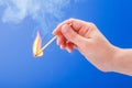 Hand holding a burning matchstick Royalty Free Stock Photo