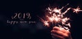 Hand holding burning Sparkler blast with happy new year 2019 on Royalty Free Stock Photo