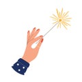 Hand holding burning sparkler fireworks