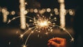 Hand holding burning sparkler with golden sparks at night Royalty Free Stock Photo