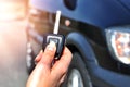 Hand holding button on the remote car. In selective focus of woman hand presses on the remote control car alarm systems. Royalty Free Stock Photo