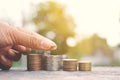 Hand holding a calculator with coin piggy bank