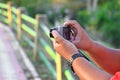 Hand holding camera photograph in nature background Royalty Free Stock Photo