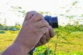 Hand holding camera photograph in nature background Royalty Free Stock Photo