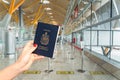 Hand holding a Canadian passport just before boarding