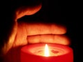 Hand holding a candle