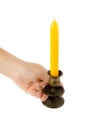 Hand holding candlesticks with yellow candle Royalty Free Stock Photo