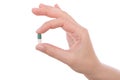 Hand holding a capsule or pill Royalty Free Stock Photo