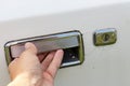 Hand holding a car door handle, trying to open the door of an old car, theft and robbery prevention concept Royalty Free Stock Photo