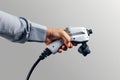 Hand holding a Car Electrical Charge Cable plug Royalty Free Stock Photo