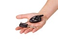 Hand holding car key and remote entry fob