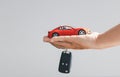 Hand holding car keys and a remote control for keyless entry. Car loan, contract agreement, buying and rent car concept, Sale Royalty Free Stock Photo
