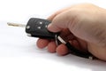 Hand holding car remote control key. White background. Car key