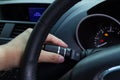 Hand holding car wiper switch