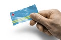 Hand holding a card with a national flag the Aruba