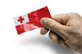Hand holding a card with a national flag the Tonga Royalty Free Stock Photo