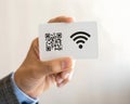 Hand holding card with qr code and wifi symbol Royalty Free Stock Photo