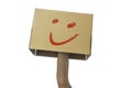 hand holding a cardboard box with smiley face isolated on white Royalty Free Stock Photo