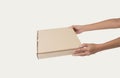 Hand holding cardboard brown paper box for pizza mockup branding Royalty Free Stock Photo