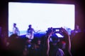 Hand holding Cell phone Blank screen Photo shot Blur Concert Background Royalty Free Stock Photo