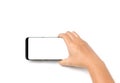 Hand holding cell phone blank on white screen and white background Royalty Free Stock Photo