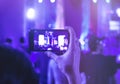 Hand holding Cell phone Camera photo shot on Concert Royalty Free Stock Photo