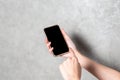 A woman's right hand holding a cell phone Left hand pointing at the screen Focus on the screen Royalty Free Stock Photo