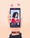 Hand holding cellphone with photo of young attractive woman on screen and hearts. Smartphone app for dating, searching Royalty Free Stock Photo