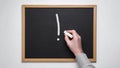 Hand holding chalk on blackboard.Exclamation point on a chalk board Royalty Free Stock Photo