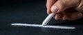 Hand Holding Chalk Creating White Line on Black Surface in Artistic Expression and Design Royalty Free Stock Photo