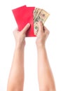 Hand holding chinese red envelope with money isolated over white background. Royalty Free Stock Photo