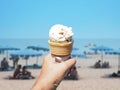 Hand holding chocolate chips ice cream cone hot summer day. Royalty Free Stock Photo
