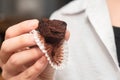 Hand Holding Chocolate Muffins. Presenting freshly baked chocolate muffins
