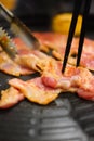 Hand holding chopstick with grilled korean pork Royalty Free Stock Photo