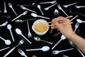 Hand holding chopsticks in bowl with noodles on black background Royalty Free Stock Photo