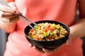 Eating fried rice with vegetables in a bowl, Asian food