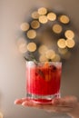 A womans hand holding a Christmas cranberry cocktail Royalty Free Stock Photo